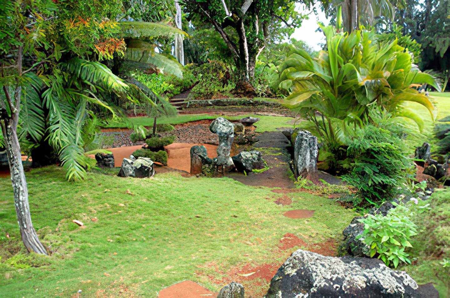 Lush foliage, volcanic rock, and garden trails at Kukuiolono Park—an intimate South Shore setting for weddings with Pastor Kilborn.